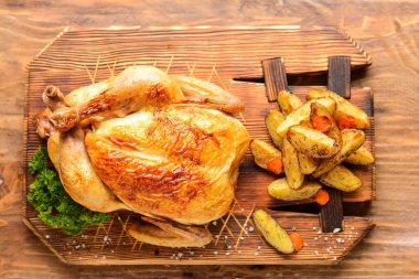 Tahta masada fırında tavuk ve patates.