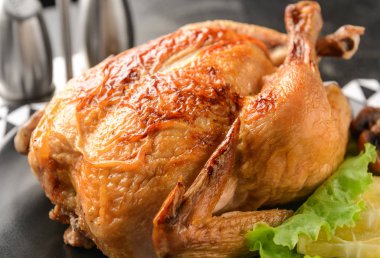 Plate with baked chicken, closeup