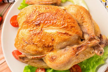 Plate with baked chicken, closeup