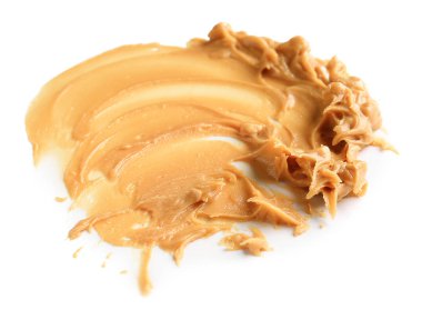 Beyaz arka planda lezzetli fıstık ezmesi.