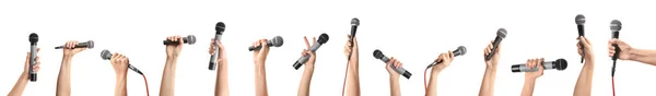 Manos femeninas con micrófonos sobre fondo blanco —  Fotos de Stock