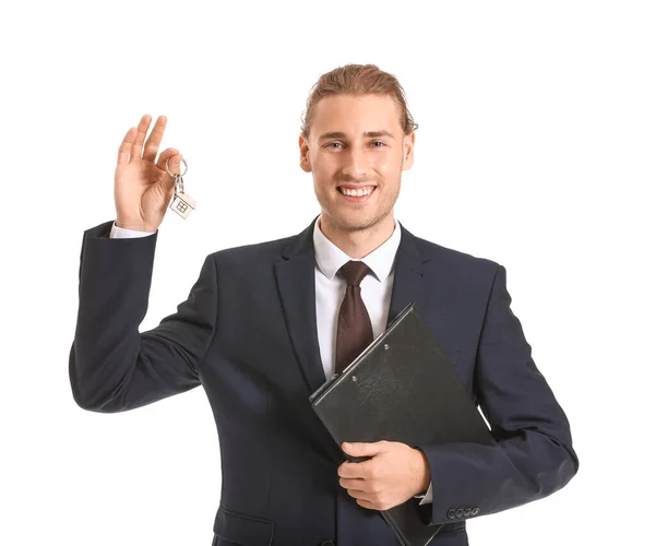 Male real estate agent with key on white background — Stock Photo, Image