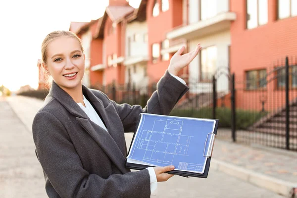 Female real estate agent near new house outdoors — Stock Photo, Image