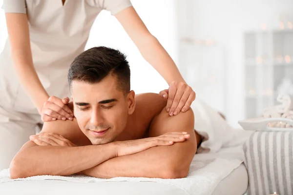 Schöner Mann mit Massage im Wellness-Salon — Stockfoto