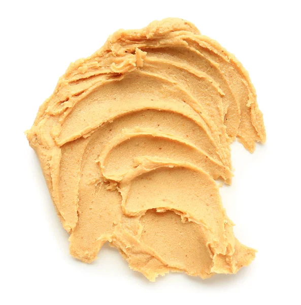 Leckere Erdnussbutter auf weißem Hintergrund — Stockfoto