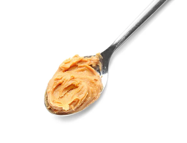 Löffel mit leckerer Erdnussbutter auf weißem Hintergrund — Stockfoto