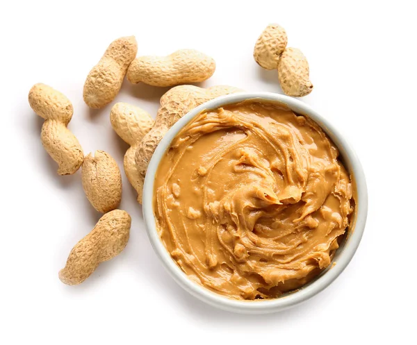 Tasty peanut butter in bowl on white background — Stock Photo, Image