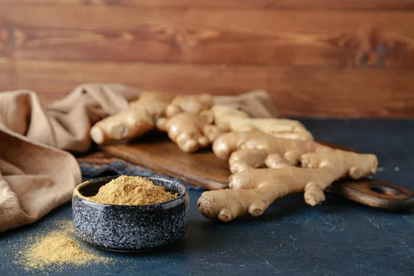 Bowl with ground ginger on dark table — Stock Photo, Image