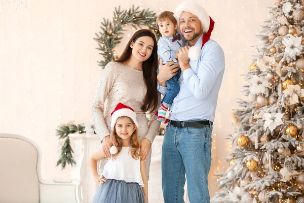 Happy family in room decorated for Christmas — Stock Photo, Image