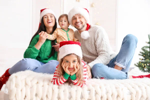 Happy family resting in bedroom on Christmas eve — Stock Photo, Image