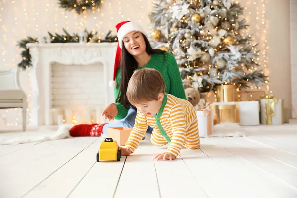 Happy mother with little son in room decorated for Christmas — Stock Photo, Image