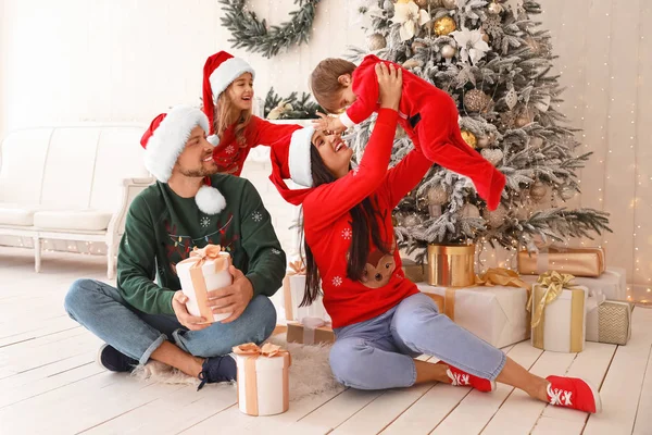 Happy family with Christmas gifts at home — Stock Photo, Image