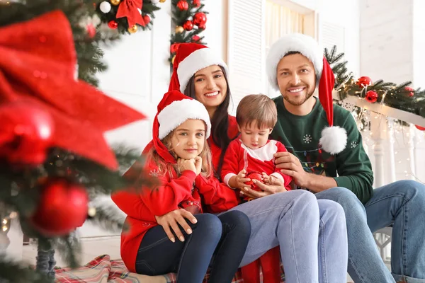 Happy family sitting on porch decorated for Christmas — Stock Photo, Image
