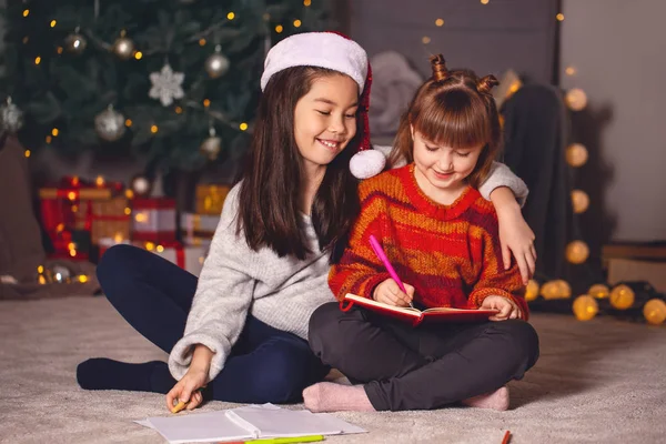 Cute little girls writing letter to Santa Claus on Christmas eve at home — Stock Photo, Image