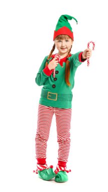 Elf kostümü giymiş küçük bir kız ve beyaz arka planda şeker kamışları.