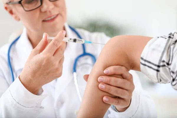 Mature doctor giving young woman with joint pain injection in clinic, closeup — Stock Photo, Image