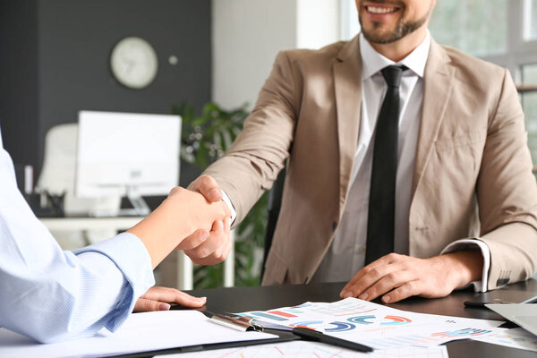 Business people shaking hands during meeting in office