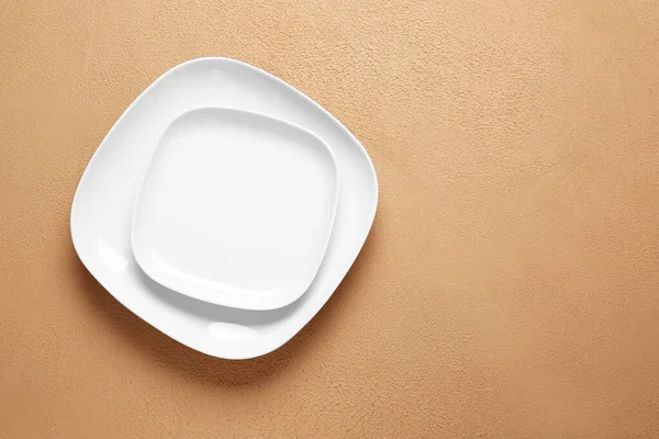 Empty plates on color background — Stock Photo, Image