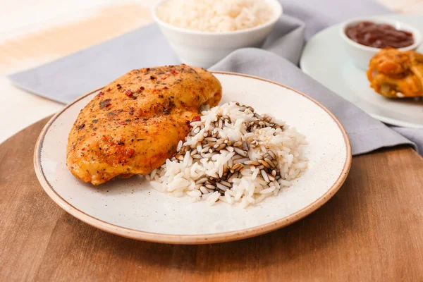 Plate with tasty rice and chicken on table — Stock Photo, Image