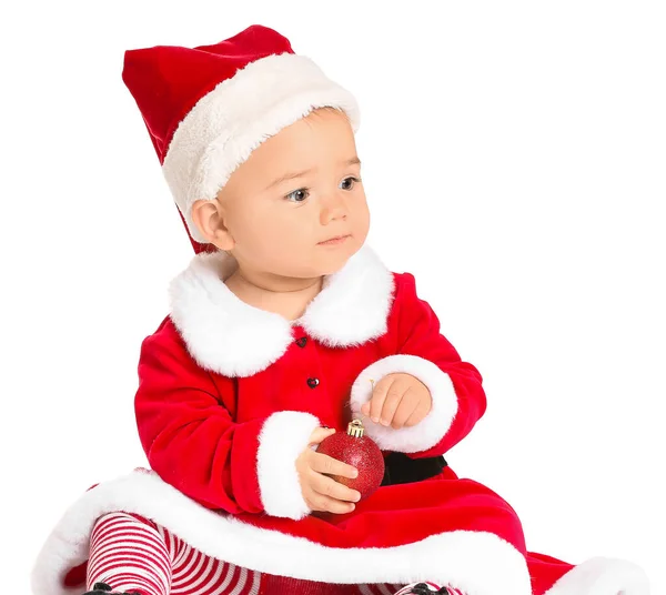 Cute little baby in Santa Claus costume and with Christmas ball on white background — Stock Photo, Image