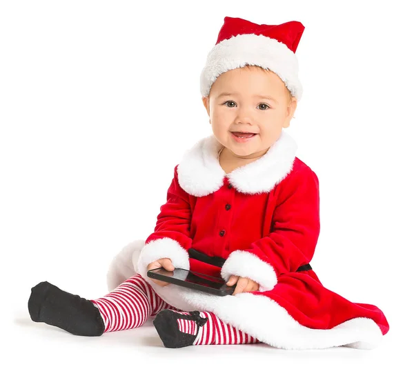 Cute little baby in Santa Claus costume and with mobile phone on white background — Stock Photo, Image