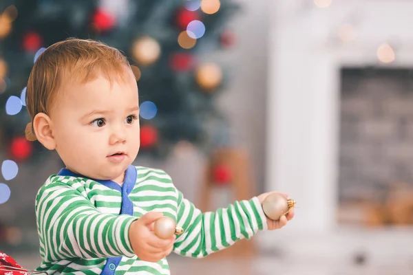 Cute little baby with Christmas balls at home — Stock Photo, Image