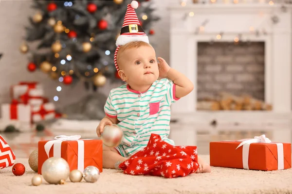 Cute little baby with Christmas gifts at home — Stock Photo, Image