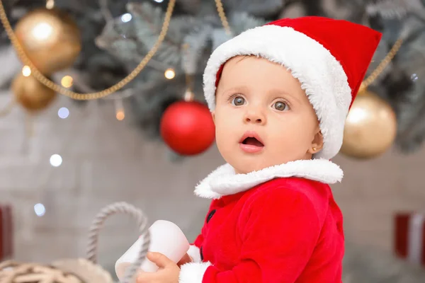 Cute little baby in Santa Claus costume on Christmas eve at home — Stock Photo, Image