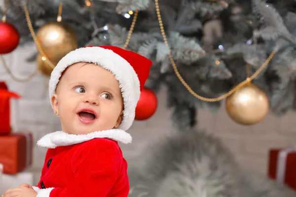 Cute little baby in Santa Claus costume on Christmas eve at home — Stock Photo, Image