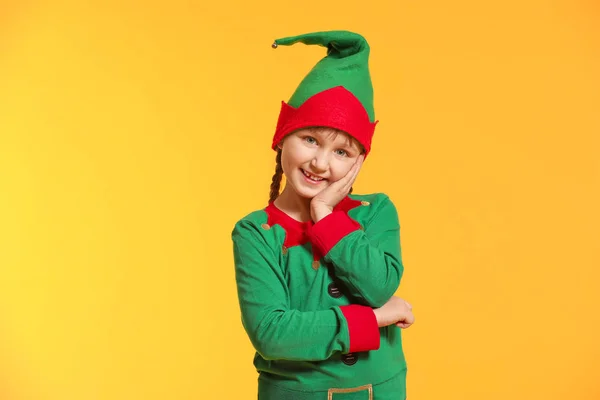 Little girl in costume of elf on color background — Stock Photo, Image