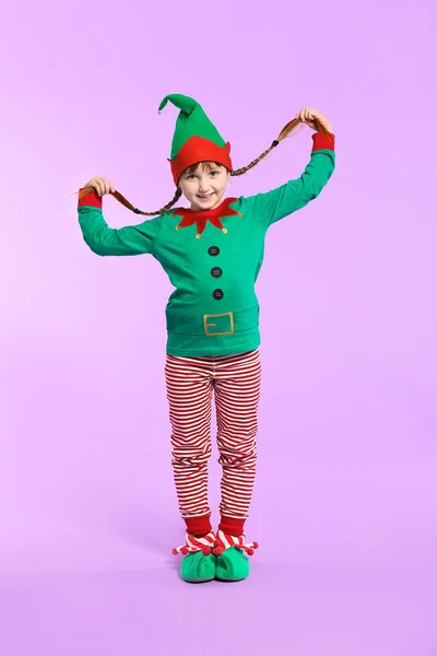 Little girl in costume of elf on color background — Stock Photo, Image