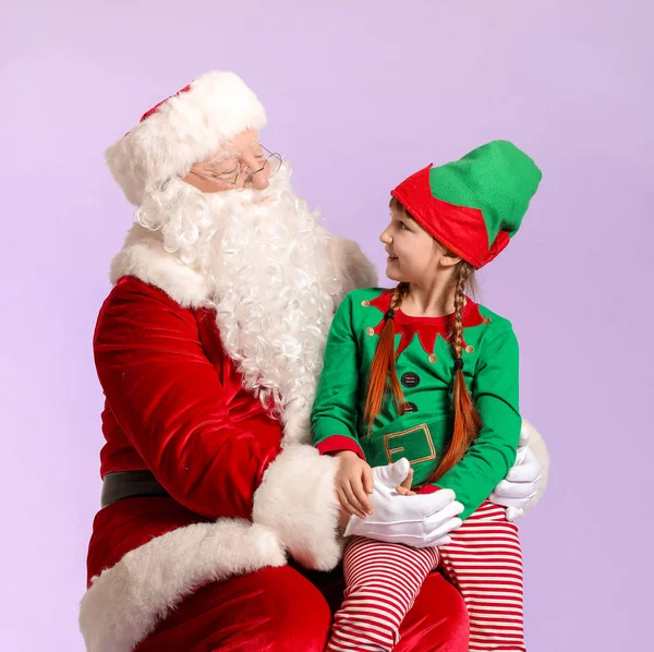 Santa Claus and little elf kid on color background — ストック写真
