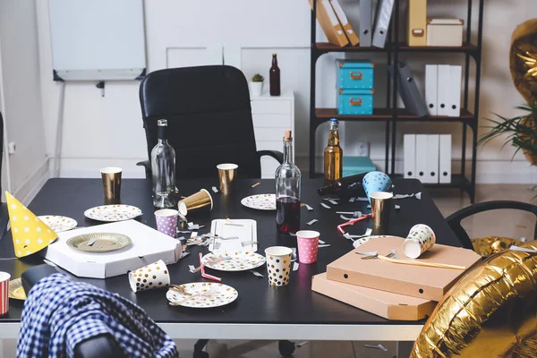 Table with terrible mess in office after New Year party — Stock Photo, Image