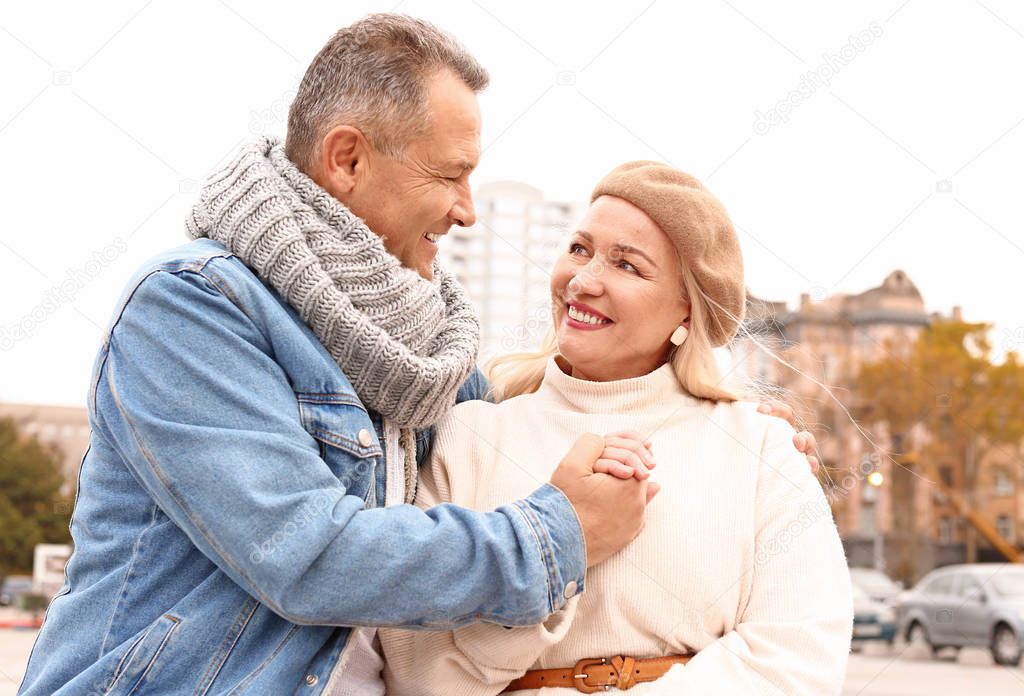 Portrait of happy mature couple outdoors on autumn day