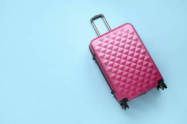 Renkli arka planda paketlenmiş giysileri olan bavul