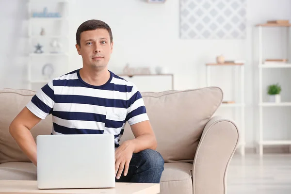 Portrait of handsome man with laptop at home — Stock Photo, Image