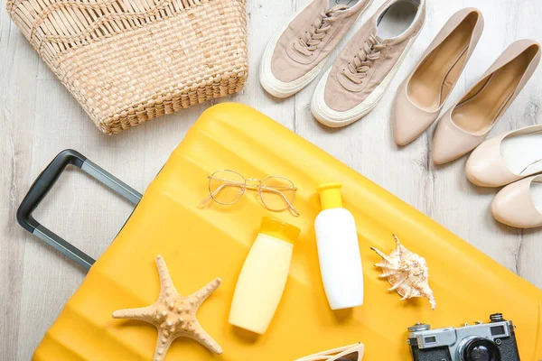 Suitcase and travel accessories with shoes on floor — 스톡 사진