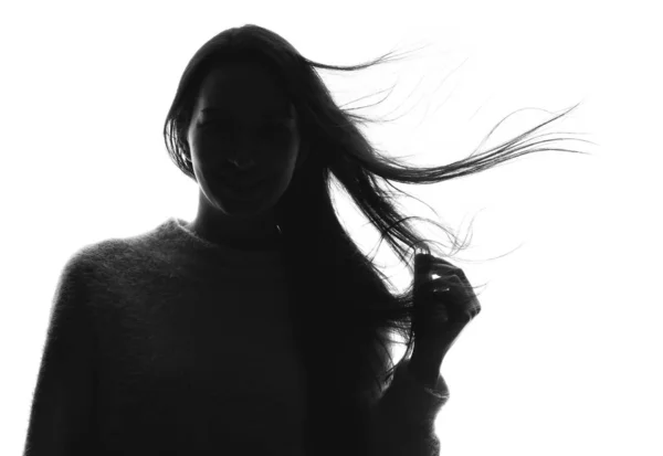 Silhouette di bella giovane donna su sfondo bianco — Foto Stock