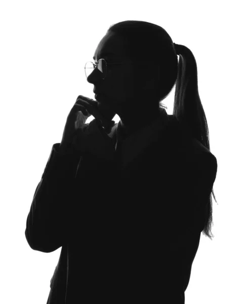 Silhouette of beautiful businesswoman talking by mobile phone on white background — Stock Photo, Image