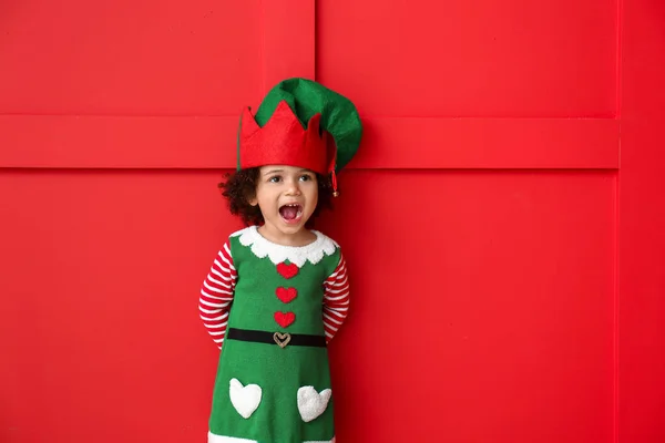 Little girl in costume of elf on color background — Stock Photo, Image