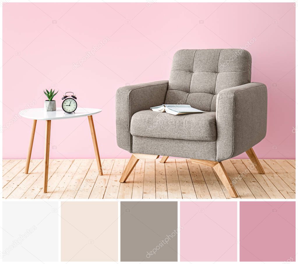 Comfortable armchair and table near color wall. Different color patterns