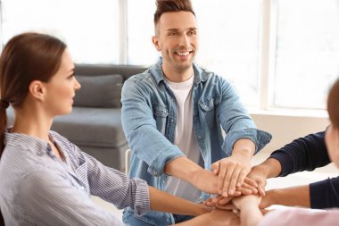 Psikolojik destek oturumunda el ele tutuşan gençler