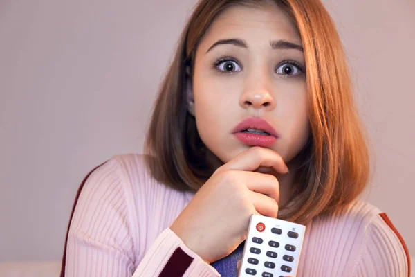 Scared teenage girl watching TV late in evening — Stock Photo, Image