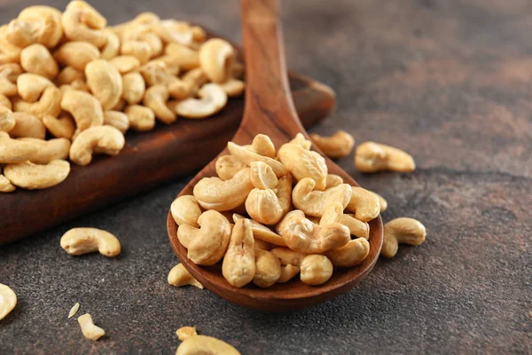 Spoon with tasty cashew nuts on table, closeup — Stock Photo, Image