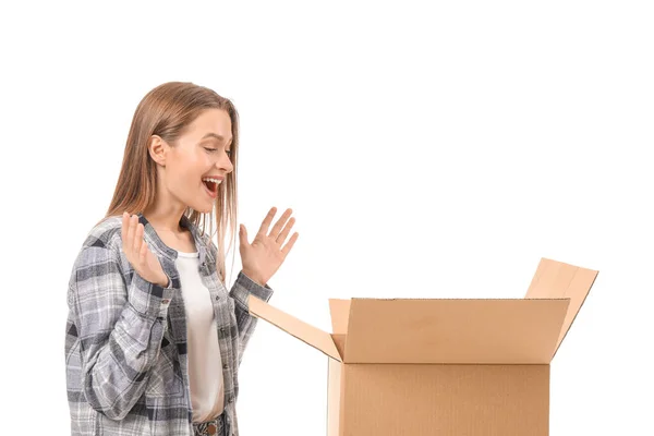 Excited young woman with open moving box on white background — ストック写真