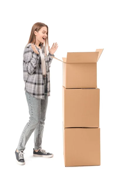 Surprised woman with moving boxes on white background — Stock Photo, Image