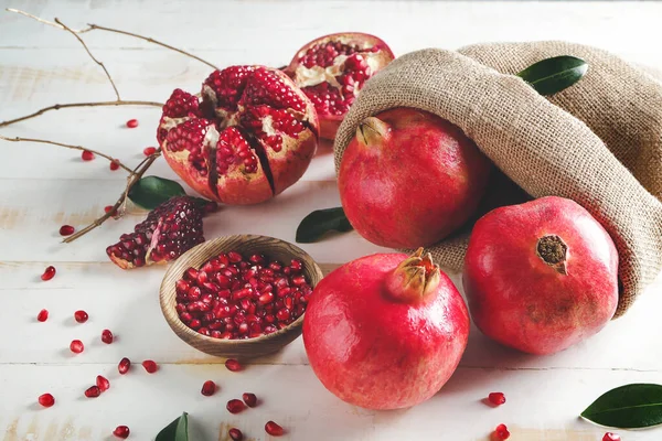 Bag with tasty pomegranate on white table — Stock Photo, Image