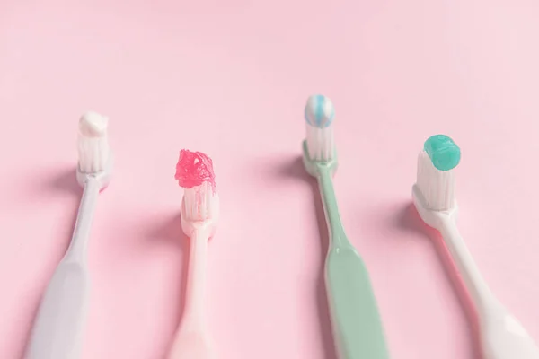 Tooth brushes with paste on color background — Stock Photo, Image