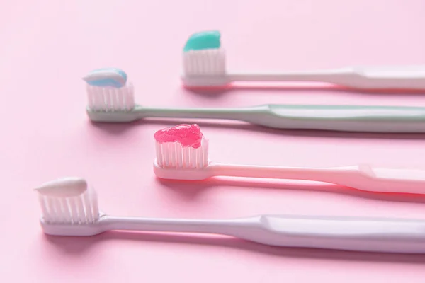 Tooth brushes with paste on color background — Stock Photo, Image