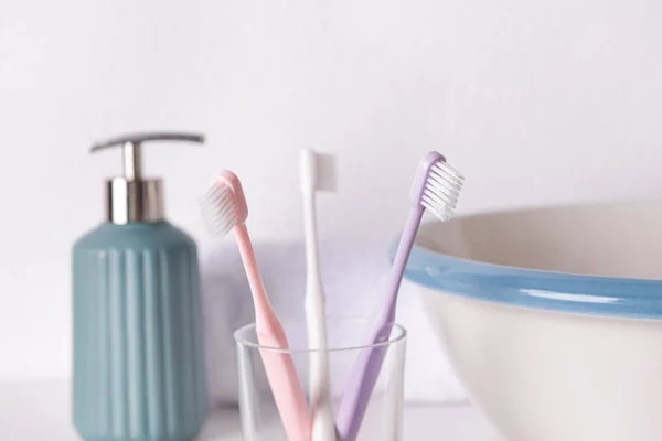 Holder with tooth brushes in bathroom — Stock Photo, Image